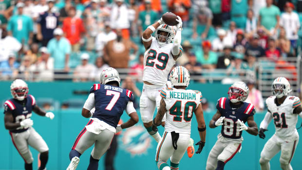 Miami Dolphins safety Brandon Jones (29) goes up for an interception as New England Patriots wide receiver JuJu Smith-Schuster (7) closes in during the second half of an NFL game at Hard Rock Stadium in Miami Gardens, Oct. 29, 2023.